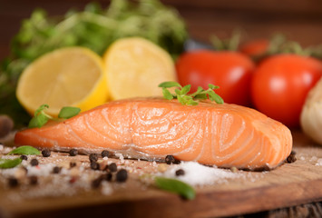 Smoked salmon slice on wooden board