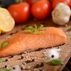 Smoked salmon slice on wooden board