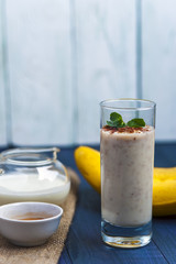 Glass of banana smoothie with mint and chocolate