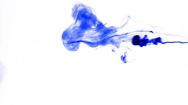Blue ink reacting in water.Creative slow motion. On a white background.