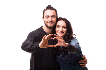 Valentine couple. Portrait of smiling beauty girl and her handsome boyfriend making shape of heart by their hands. Happy joyful family. Love concept. Heart sign. Laughing happy lovers. Valentines Day