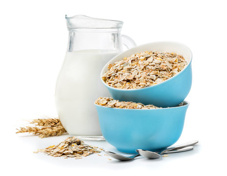 muesli in blue masks and milk jug isolated on white 