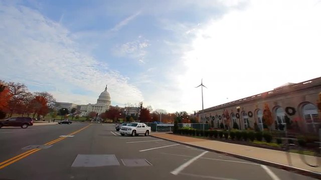Tracking shot of a road leading to the United States Capitol.