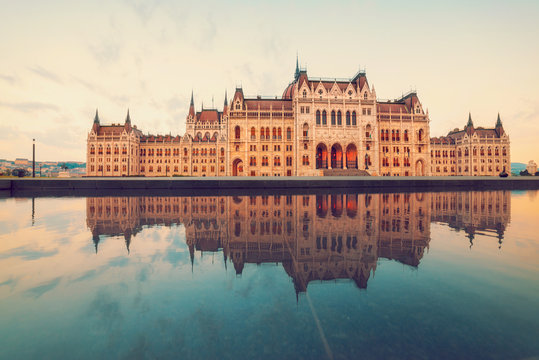 Parliament building in Budapest on a sunrise with reflection