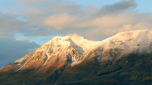 Time-lapse of the snow-capped Wasatch Mountains at dusk.
