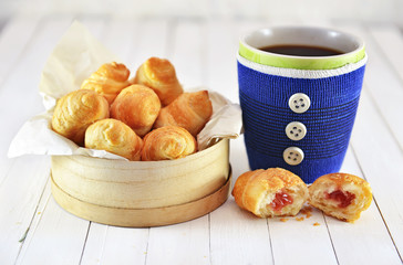 Still life with blue decorated cup and croissants