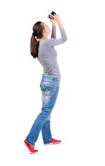 Back view of woman photographing.