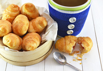 Still life with fresh croissants and blue decorated cup