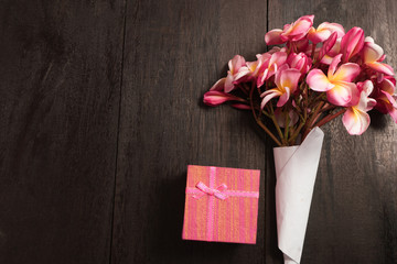 FreshFresh tulips and gift box over wooden table background and