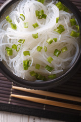 Chinese cellophane noodles close up in a bowl. Vertical top view
