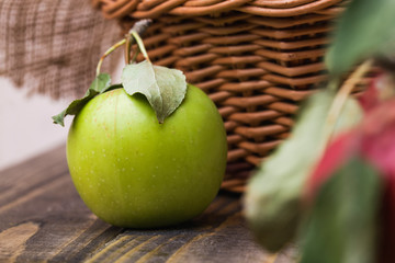 Green apple near basket