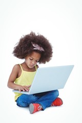 Fototapeta na wymiar Cute girl sitting on floor using laptop