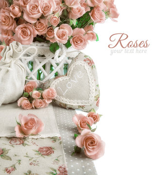 Border image with many pink roses and stuffed heart on white