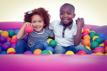 Fototapeta na wymiar Cute children in ball pool holding balls