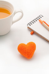Knitted fabrics heart shape, Note paper and orange juice isolate