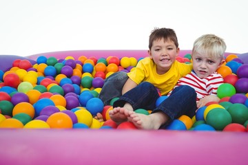 Fototapeta na wymiar Cute smiling boys in sponge ball pool