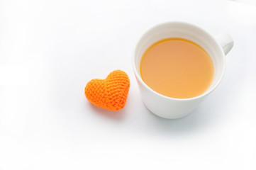 Knitted fabrics heart shape and orange juice isolated on white b