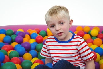Obraz premium Cute smiling boy in sponge ball pool