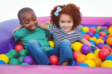 Fototapeta na wymiar Cute smiling kids in sponge ball pool