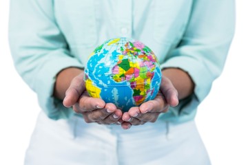 Mid section of a businesswoman holding globe