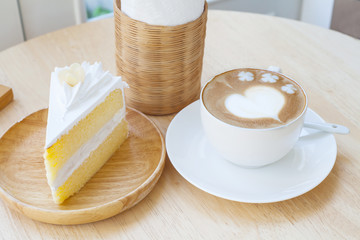 heart symbol on latte coffee cup on table