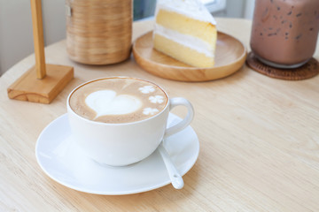 heart symbol on latte coffee cup on table