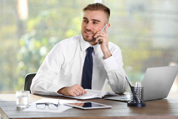 Businessman working with laptop in office