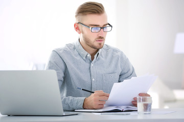 Businessman working with laptop in office