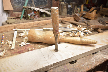 carpenter working with plane on wooden