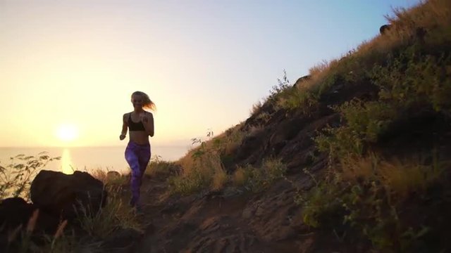 Young Athletic Woman Running on Mountain Trail. POV Follow Cam. Sunset Workout in Nature. 