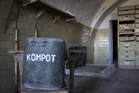 Dining room in old abandoned prison. Translation of the inscription "KOMPOT" - compote (stewed fruit)