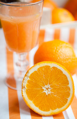 Oranges cut set on stripped white-orange mat 