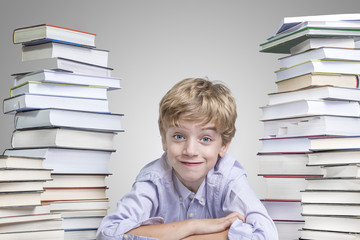 Boy happy to learn from a bunch of books