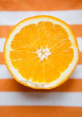 Oranges cut set on stripped white-orange mat 