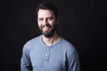 Fototapeta premium Portrait of a men with beard and mustache in studio black background
