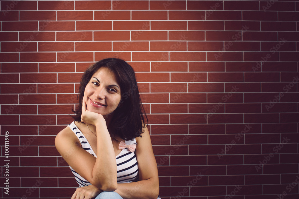 Canvas Prints smiling woman at brick wall