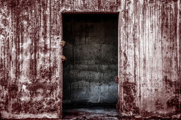 scary abandoned building with blood wall and ghost hand coming out of a door