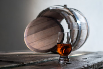 A glass of spirits in the oak barrel