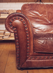 Closeup texture of vintage brown leather armchair in  library