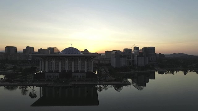 Aerial footage of Sultan Mizan Zainal Abidin mosque also known as the Iron Mosque or Masjid Besi, and and beautiful buildings in Putrajaya taken during sunrise