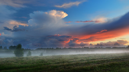 Sunset over a misty field in countryside Latvia - 100116514