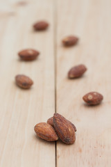 Almonds on wooden background.