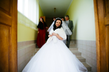 Fototapeta premium Beautiful charming bride in a luxurious dress looking up. blurre