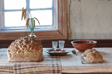 Bread and kitchenware in the table in the house of a peasant. Ukraine