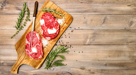 Rib Eye Steak with herbs spices. Food background