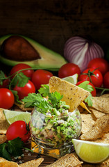 Mexican fast food, corn nachos with guacamole sauce with avocado