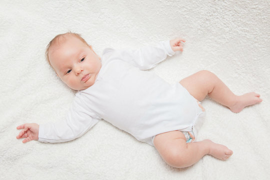 Newborn baby in white romper