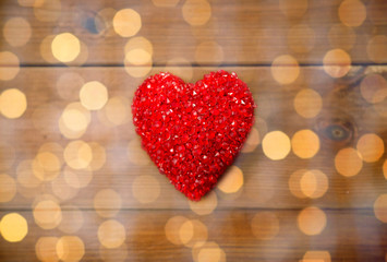 close up of red heart decoration on wood