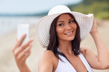 young woman taking selfie with smartphone