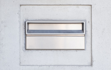 Metal mail box on concrete wall building